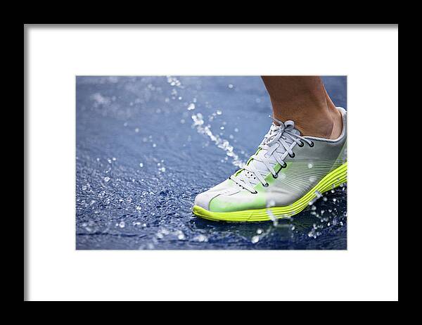 Young Men Framed Print featuring the photograph Running Shoe Splashing Water On Track by Robin Skjoldborg