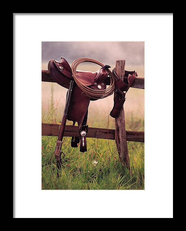 Rope Framed Print featuring the photograph Saddle And Lasso On Fence by Comstock