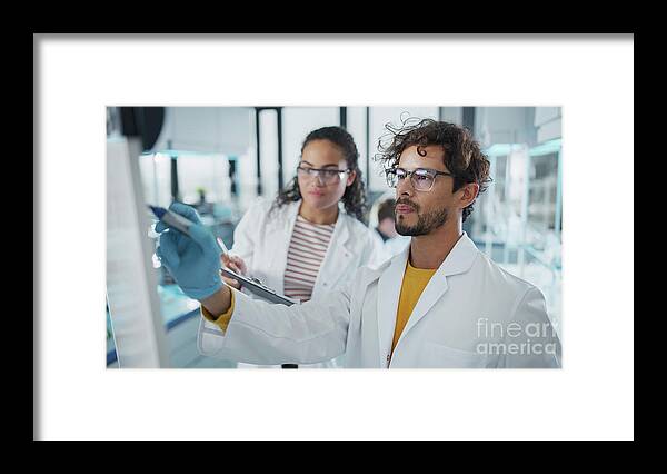 Presentation Framed Print featuring the photograph Scientist Writing On Whiteboard by Gorodenkoff Productions/science Photo Library