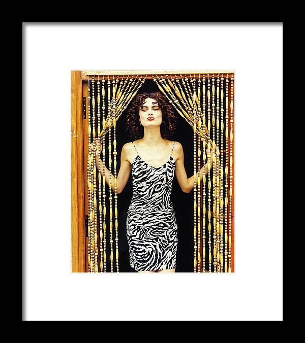 #new2022vogue Framed Print featuring the photograph Shalom Harlow Peeking Through Beaded Curtains by Arthur Elgort