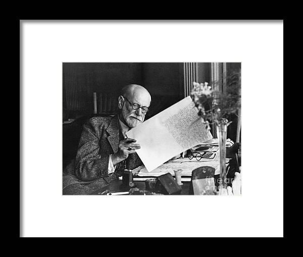 Working Framed Print featuring the photograph Sigmund Freud In Home Office At Desk by Bettmann