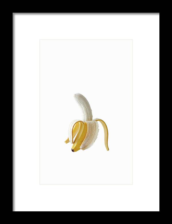 White Background Framed Print featuring the photograph Skin Of Banana Peeled Off Half by Michael H
