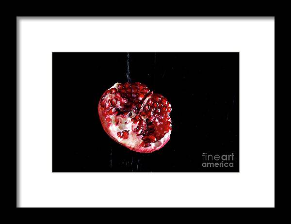 Black Background Framed Print featuring the photograph Sliced Pomegranate In Front Of Black by Westend61