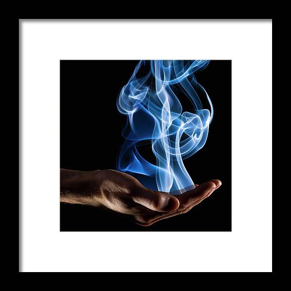 People Framed Print featuring the photograph Smoke Wisps From A Hand by Design Pics/corey Hochachka