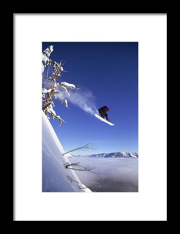 People Framed Print featuring the photograph Snowboarder In Mid-air by Comstock Images