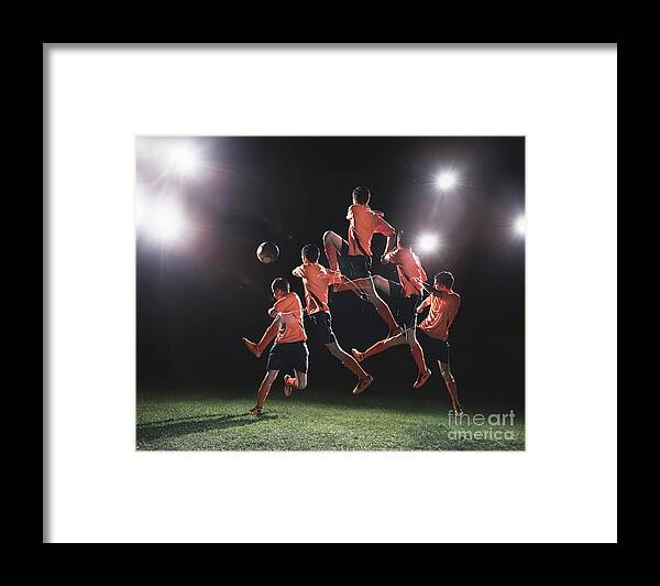 Expertise Framed Print featuring the photograph Soccer Player Jumping To Ball Multiple by Stanislaw Pytel