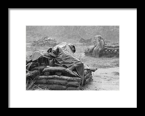 Following Framed Print featuring the photograph Soldier Sleeping During Downpour by Bettmann