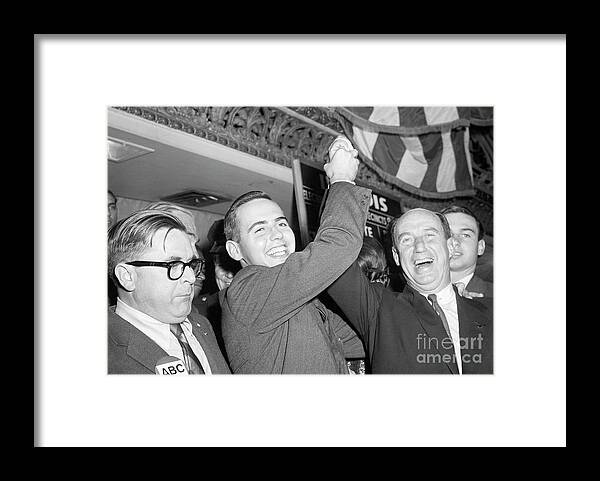 Young Men Framed Print featuring the photograph Son Holding Up Adlai Stevensons Hand by Bettmann