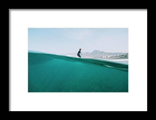 Lifestyles Framed Print featuring the photograph Split Image Of Female Surfer Surfing A Wave On A Sunny Day by Cavan Images