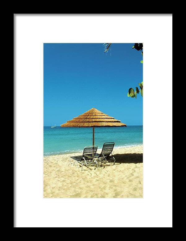 Shadow Framed Print featuring the photograph Straw Umbrella And Lounge Chairs On by Medioimages/photodisc