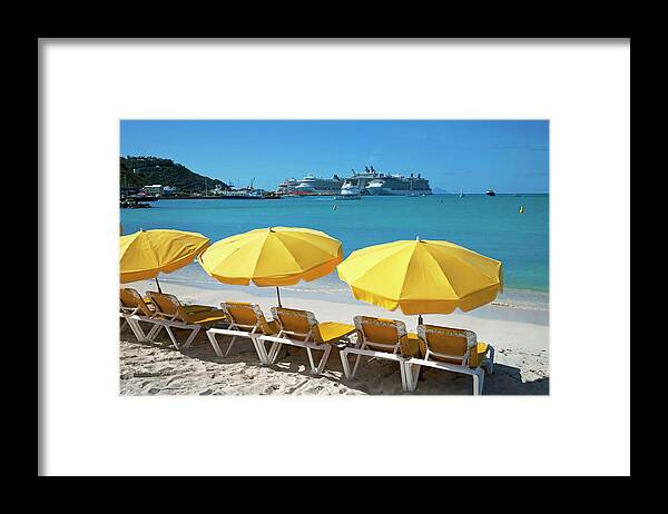 In A Row Framed Print featuring the photograph Sun Loungers On Beach With Cruise Ship by Onfilm