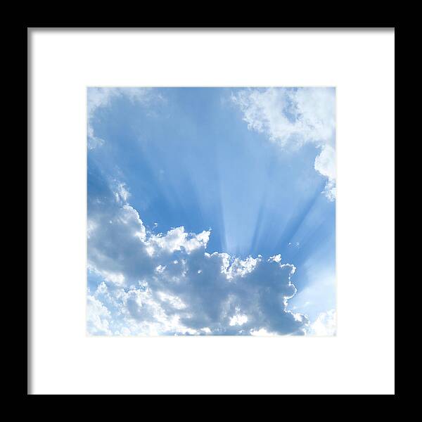 Scenics Framed Print featuring the photograph Sun Shining Through Puffy Clouds by Rtyree1