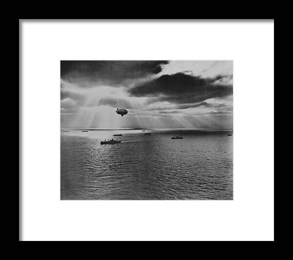 Sunset Framed Print featuring the painting Sunset over the Atlantic finds another United Nations convoy moving peacefully towards it destination. A U.S. Navy blimp, hovering watchfully overhead, is on the lookout for any sign of enemy submarines by 
