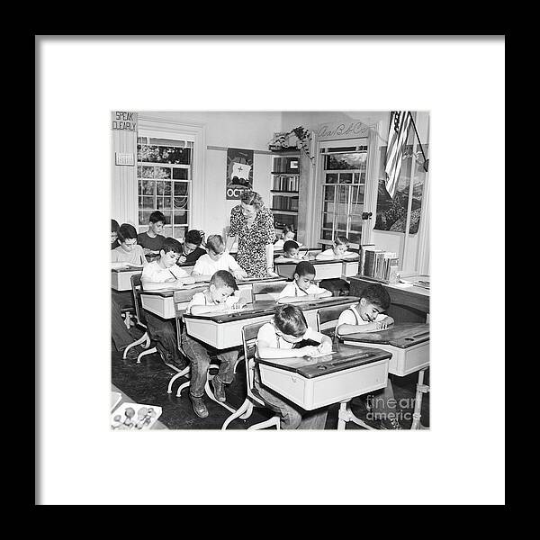 Education Framed Print featuring the photograph Teacher Supervises Students Taking Quiz by Bettmann