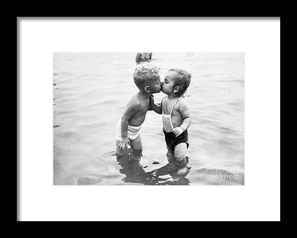 Lake Michigan Framed Print featuring the photograph Toddlers Kissing In Lake Michigan by Bettmann