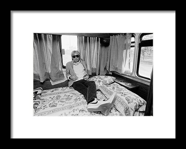 Tom Petty Framed Print featuring the photograph Tom Petty Poses In His Tour Bus by George Rose