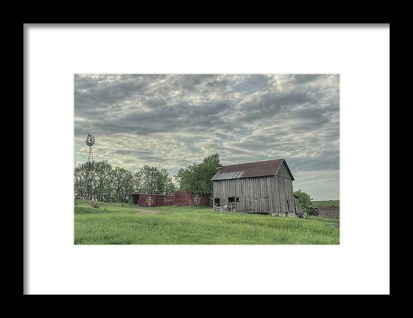 Clouds Framed Print featuring the photograph Train Cars and a Barn by Laura Hedien
