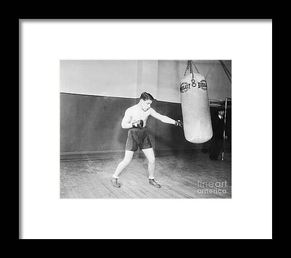 Young Men Framed Print featuring the photograph Tuffy Griffith Working The Weight Bag by Bettmann