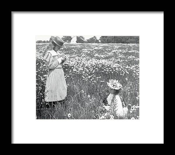 Child Framed Print featuring the photograph Two Girls In Field Of Daisies by Bettmann