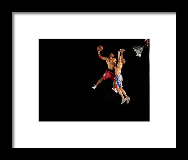Young Men Framed Print featuring the photograph Two Male Basketball Players Jumping Mid by 10'000 Hours