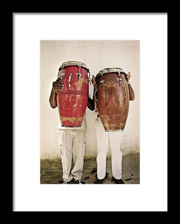 Hiding Framed Print featuring the photograph Two Men Holding Bongos In Front Of by Holly Wilmeth