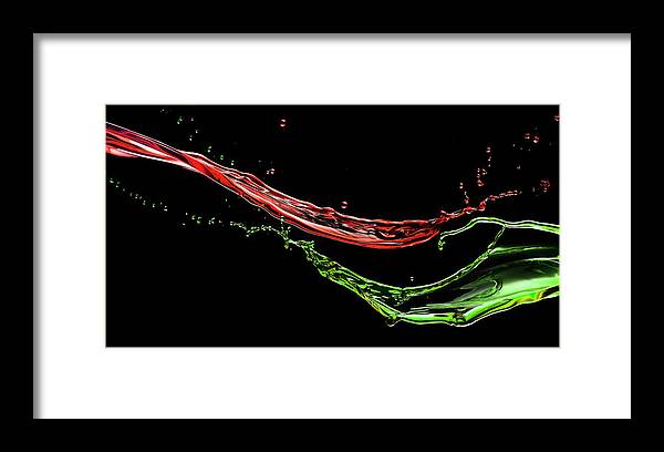 Black Background Framed Print featuring the photograph Two Splashes Of Colored Liquid by Biwa Studio