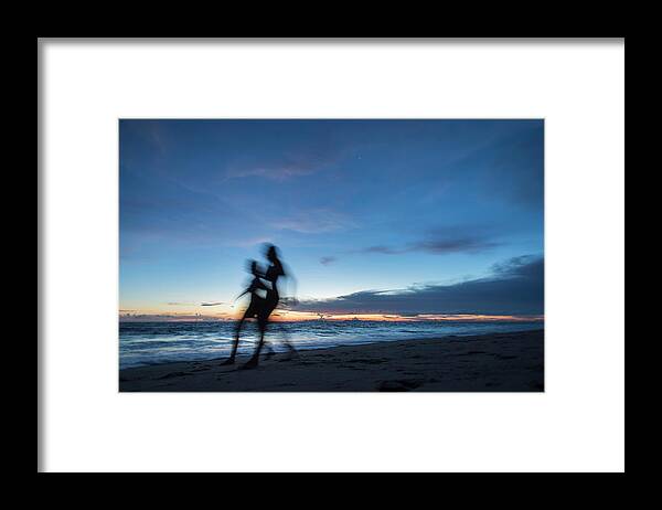 Asia Framed Print featuring the photograph Two Women Running On A White Sand Beach At Sunset Time, Koh Lanta Island, Thailand. by Cavan Images