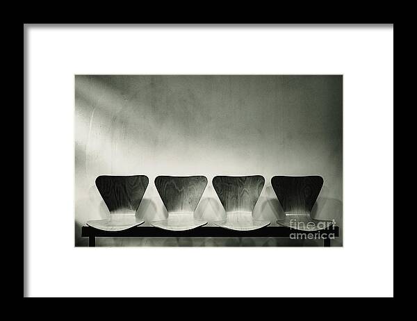 Appointment Framed Print featuring the photograph Waiting room with empty wooden chairs, concept of waiting and passage of time, black and white image, free space for text. by Joaquin Corbalan
