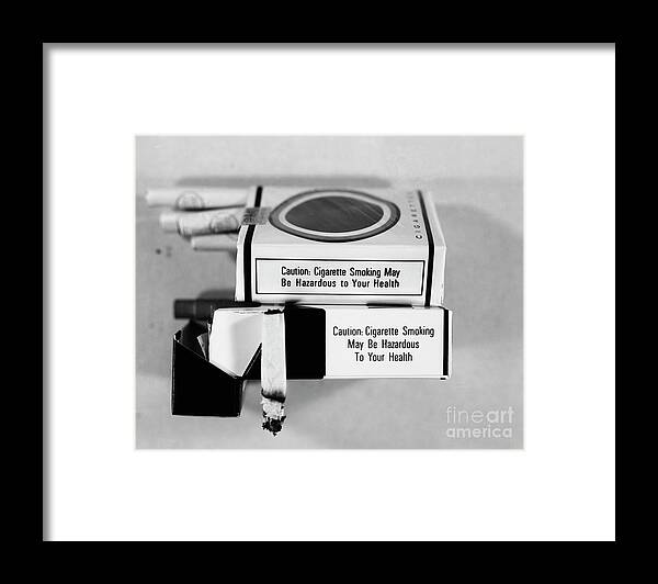Temptation Framed Print featuring the photograph Warning Labels On Cigarettes by Bettmann