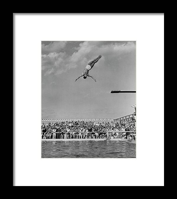 Diving Into Water Framed Print featuring the photograph Watching A Dive by Pictorial Parade