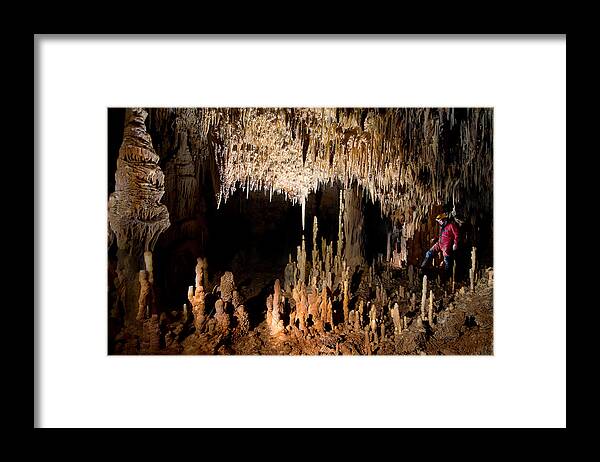 Cave Framed Print featuring the photograph While Crossing The Chamber Of Candles by Christian Roustan (kikroune)