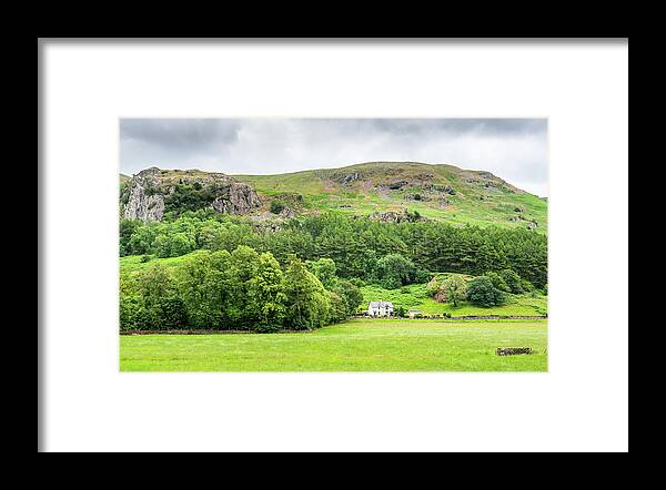 Lake District Framed Print featuring the photograph White cottage house on the picturesque green farmlands at the La by Michalakis Ppalis