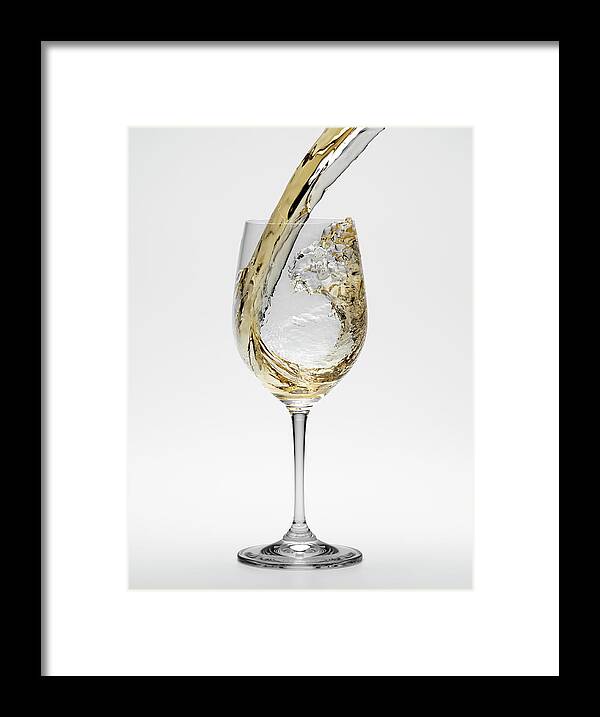 White Background Framed Print featuring the photograph White Wine Being Poured Into Wineglass by Don Farrall