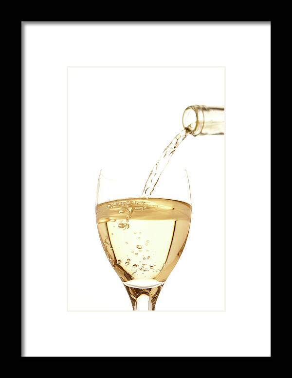 White Background Framed Print featuring the photograph White Wine Pouring Into A Glass by Ross Durant Photography