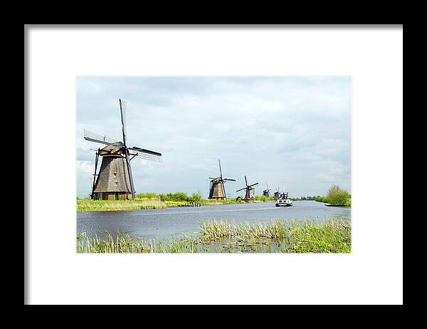 In A Row Framed Print featuring the photograph Windmills In Holland by Robas