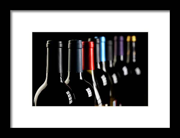 Alcohol Framed Print featuring the photograph Wine Bottles In A Row On Black by Hirkophoto