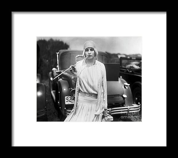 Smoking Framed Print featuring the photograph Woman Holding Long Cigarette Holder by Bettmann