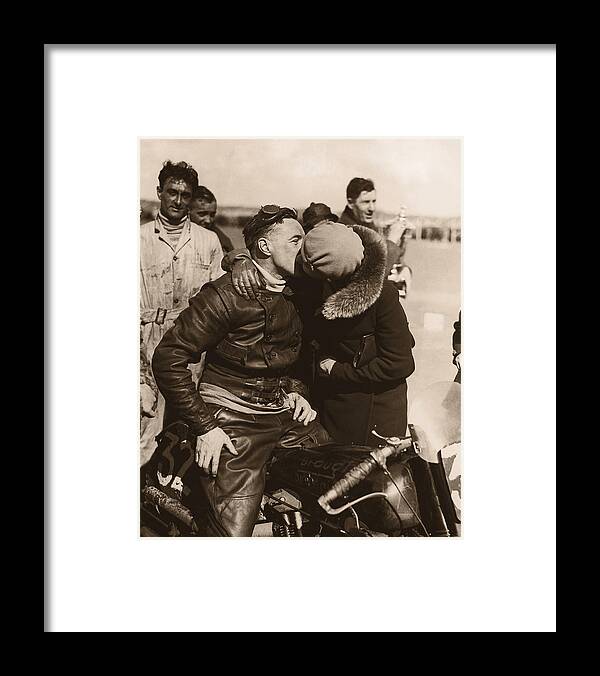 Heterosexual Couple Framed Print featuring the photograph Woman Kissing Motorcycle Racer B&w by Fpg