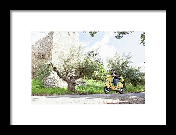 Crash Helmet Framed Print featuring the photograph Woman On Scooter Riding Around Corner by Stefanie Grewel