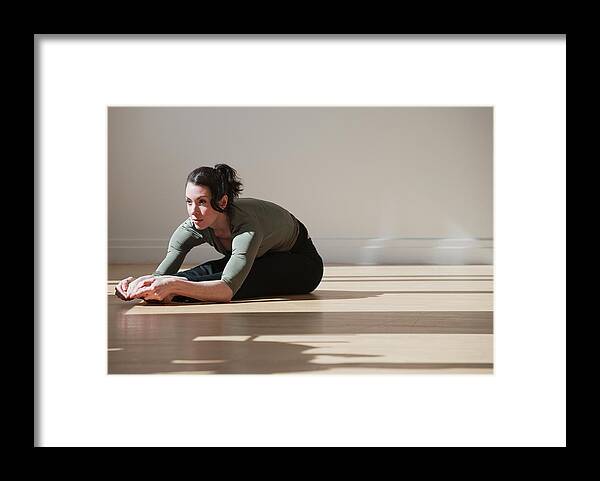 Ballet Dancer Framed Print featuring the photograph Woman Performing Stretching Exercise by Tetra Images