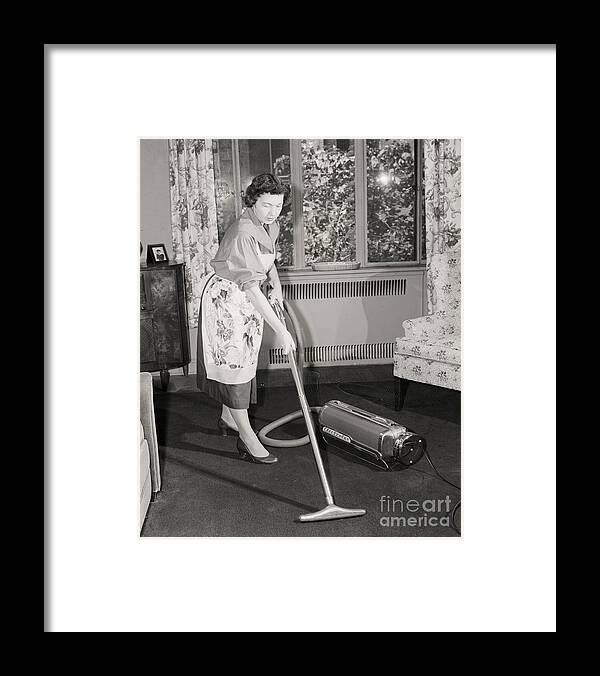 Homemaker Framed Print featuring the photograph Woman Vacuuming Carpet by Bettmann