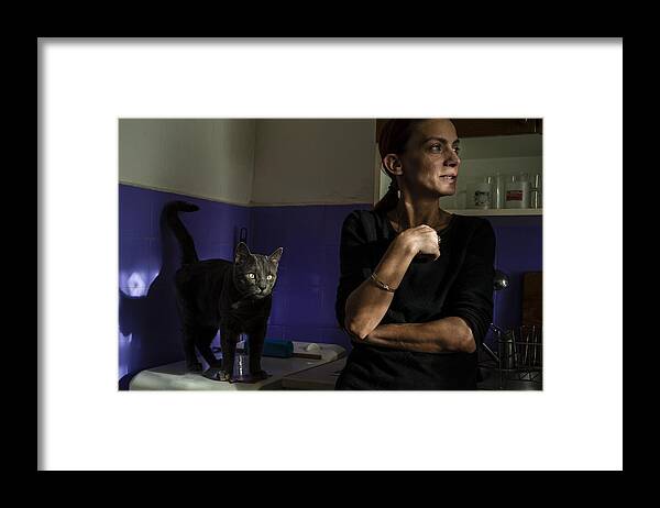 Cat Framed Print featuring the photograph Woman With Cat In The Kitchen by Sorin Vidis