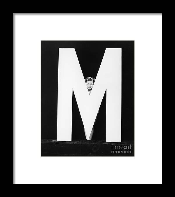 Behind Framed Print featuring the photograph Womans Face With Huge Letter M by Everett Collection