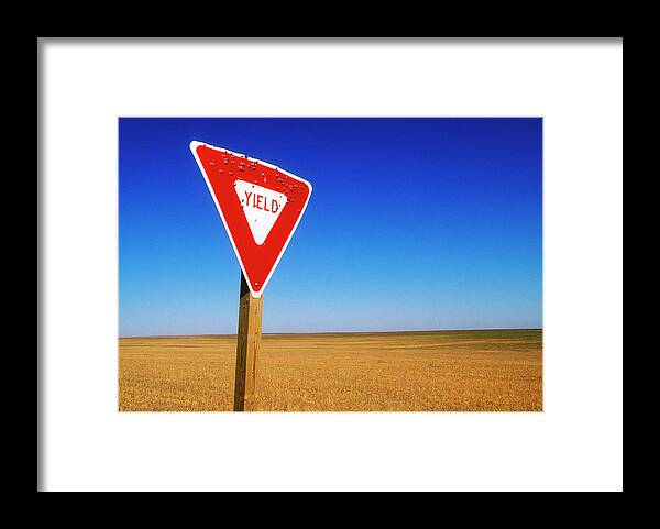 Tranquility Framed Print featuring the photograph Yield Road Sign With Bullet Holes In It by Wesley Hitt