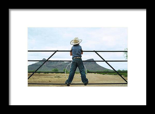 Child Framed Print featuring the photograph Young Boy 7-8 Standing On Ranch Railing by John Slater