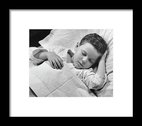 Child Framed Print featuring the photograph Young Boy Asleep In Bed by George Marks