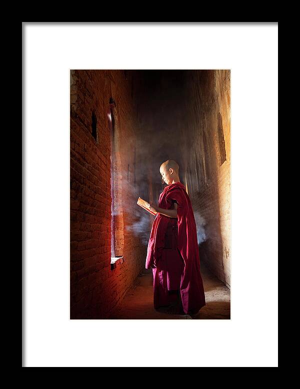 Tranquility Framed Print featuring the photograph Young Buddhist Monk Reading In Pagoda by Peter Adams