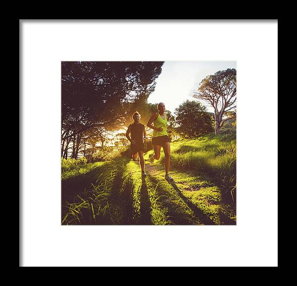 Heterosexual Couple Framed Print featuring the photograph Young Couple Jogging by Wundervisuals