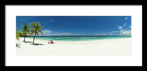 Young Men Framed Print featuring the photograph Young Couple Relaxing On Beach by Dstephens