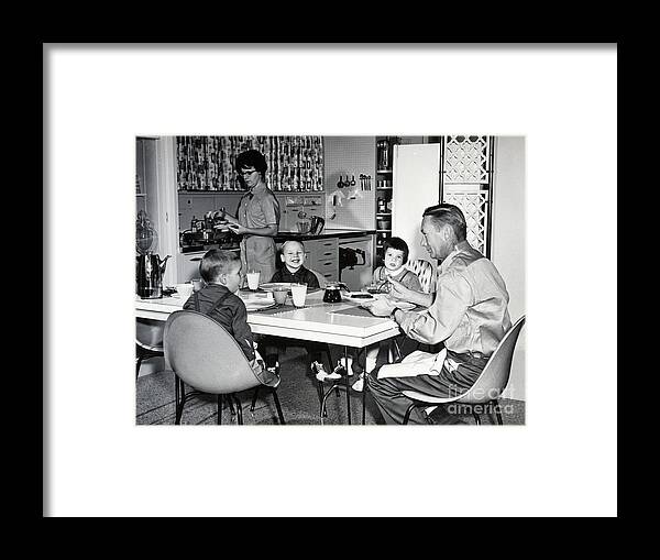 Breakfast Framed Print featuring the photograph Young Family Eating Breakfast In Kitchen by Bettmann